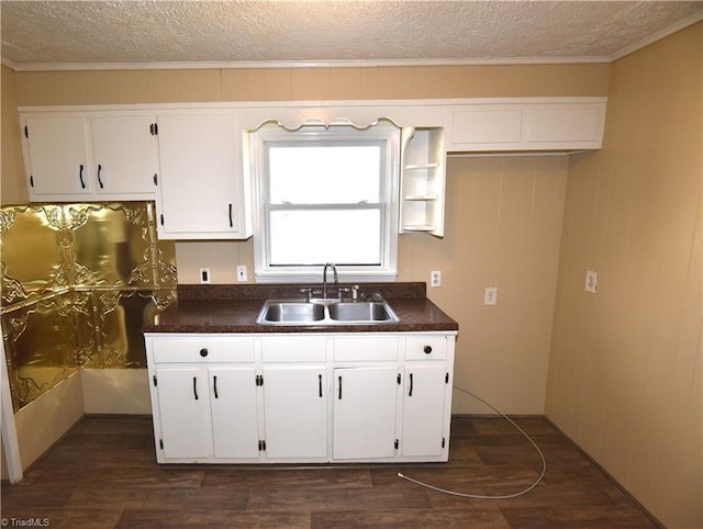 kitchen with white cabinetry, sink, a textured ceiling, and dark hardwood / wood-style floors