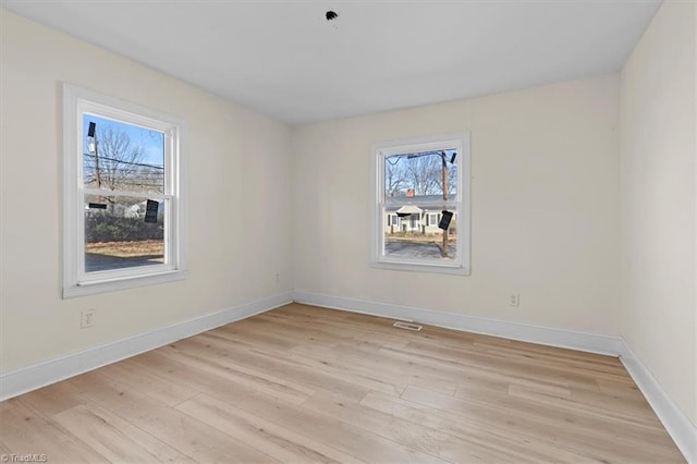 spare room featuring light wood-type flooring