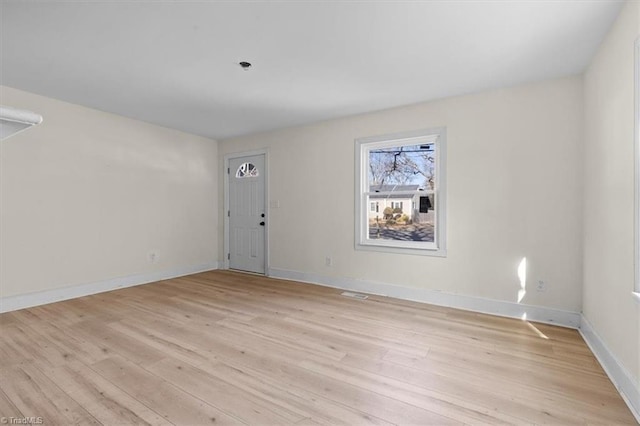 spare room featuring light wood-type flooring