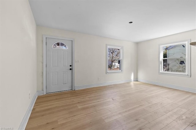 entryway with a wealth of natural light and light hardwood / wood-style floors