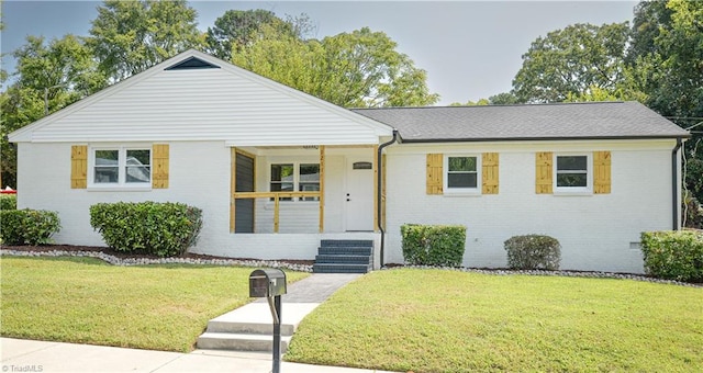 view of front of house with a porch and a front lawn