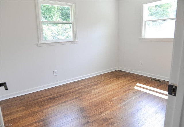 unfurnished room featuring hardwood / wood-style flooring