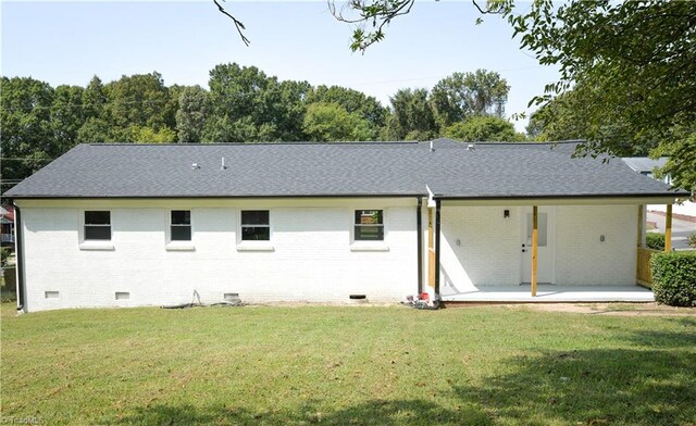 rear view of house featuring a lawn and a patio area