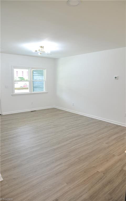 spare room featuring hardwood / wood-style flooring