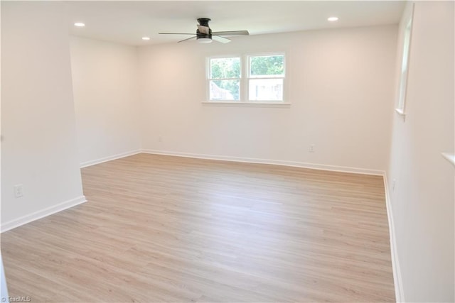 spare room featuring ceiling fan and light wood-type flooring