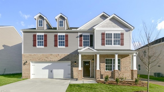 233 Lisa Ln, Winston-Salem, NC 27107 - view of front of property with brick siding, concrete driveway, an attached garage, cooling unit, and a porch