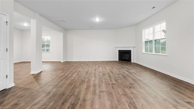 233 Lisa Ln, Winston-Salem, NC 27107 - unfurnished living room featuring wood finished floors, baseboards, and a fireplace