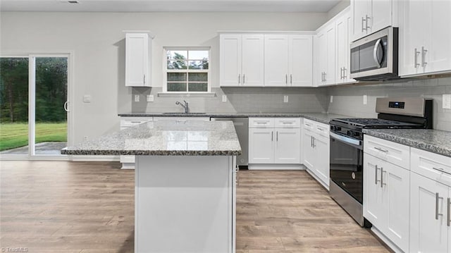 233 Lisa Ln, Winston-Salem, NC 27107 - kitchen with stainless steel appliances, light wood-type flooring, a center island, and plenty of natural light