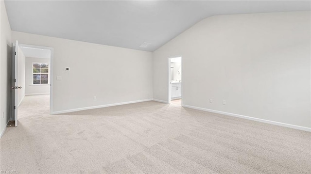 233 Lisa Ln, Winston-Salem, NC 27107 - unfurnished room with vaulted ceiling, light carpet, and baseboards