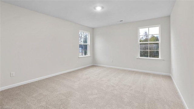 233 Lisa Ln, Winston-Salem, NC 27107 - empty room with light carpet and healthy amount of natural light