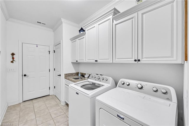 laundry room with cabinets, light tile patterned floors, independent washer and dryer, and crown molding