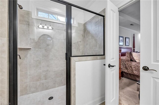 bathroom featuring a shower with shower door and ornamental molding