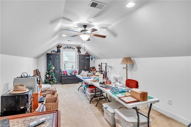 office space with ceiling fan, light colored carpet, and vaulted ceiling