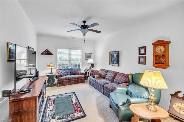 carpeted living room with ceiling fan and crown molding