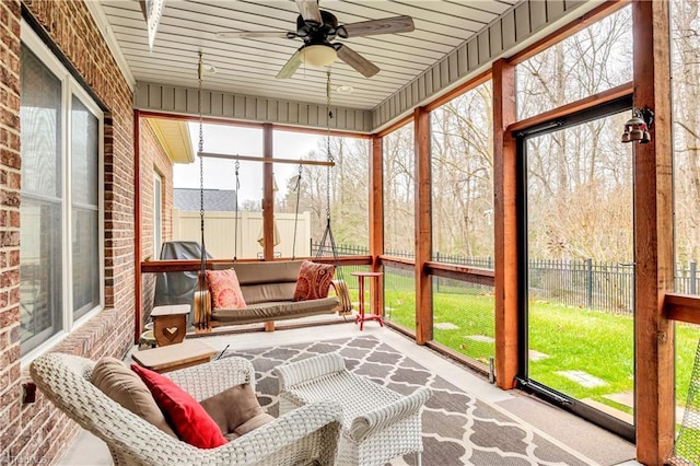 sunroom featuring ceiling fan