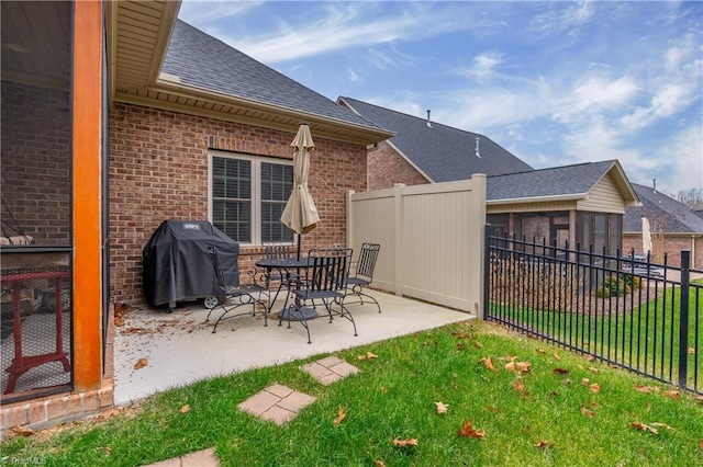 exterior space featuring a grill and a sunroom