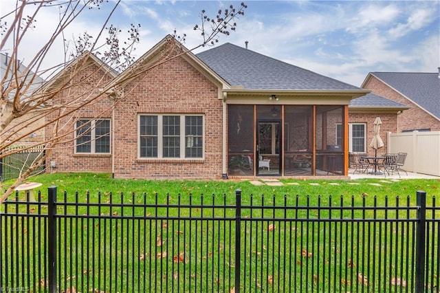 back of house featuring a sunroom, a patio area, and a yard