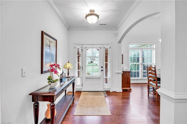 foyer featuring crown molding and dark hardwood / wood-style flooring