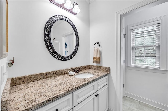 bathroom featuring tile patterned floors, vanity, and a healthy amount of sunlight