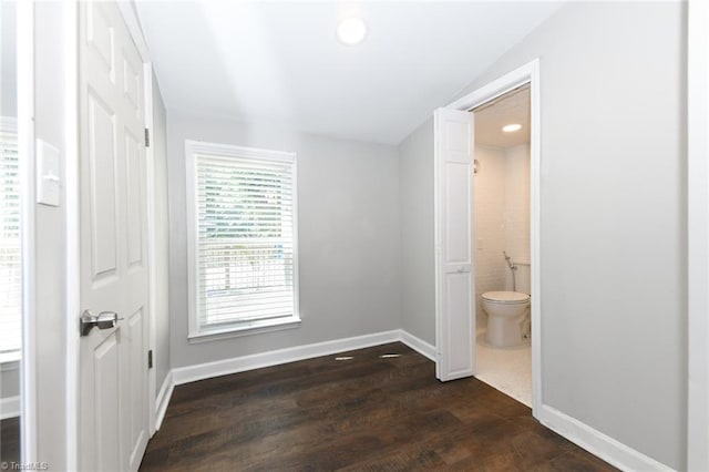 1449 NC Highway 150, Summerfield, NC 27358 - unfurnished bedroom with dark wood-style floors, baseboards, ensuite bathroom, recessed lighting, and lofted ceiling