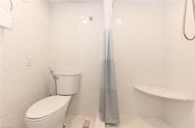1449 NC Highway 150, Summerfield, NC 27358 - bathroom with toilet, a tile shower, tile walls, and tile patterned floors