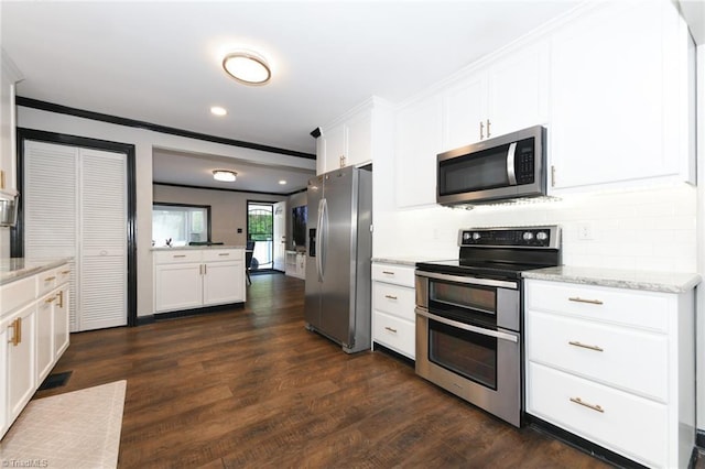 1449 NC Highway 150, Summerfield, NC 27358 - kitchen featuring appliances with stainless steel finishes, ornamental molding, white cabinets, dark wood-type flooring, and decorative backsplash