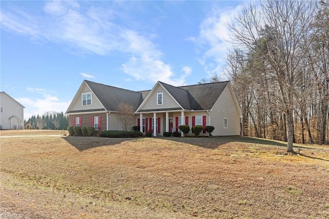 new england style home with a porch and a front yard