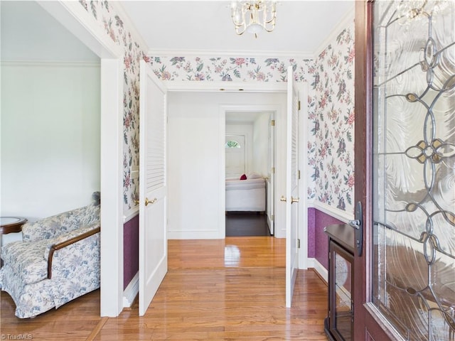 4208 Aberdare Dr, High Point, NC 27265 - entryway with wallpapered walls, wood finished floors, baseboards, a chandelier, and ornamental molding
