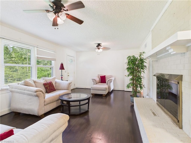 4208 Aberdare Dr, High Point, NC 27265 - living room with a ceiling fan, a textured ceiling, wood finished floors, a brick fireplace, and crown molding