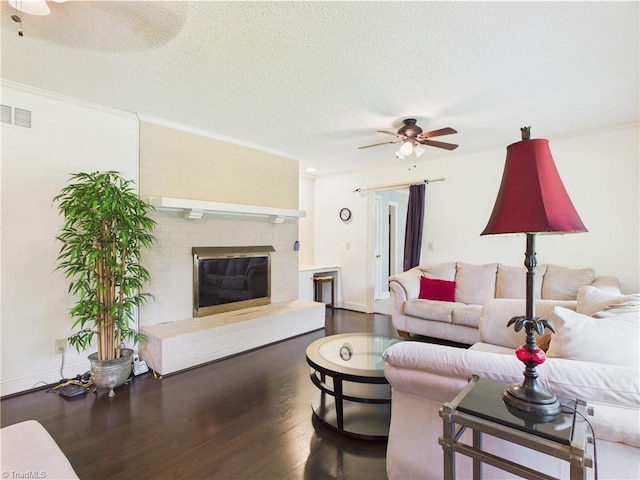 4208 Aberdare Dr, High Point, NC 27265 - living area with ceiling fan, wood finished floors, a textured ceiling, a fireplace, and baseboards