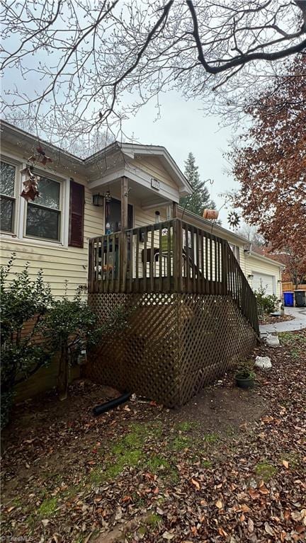 exterior space with a garage and a deck