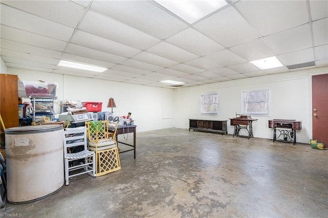 interior space with a paneled ceiling