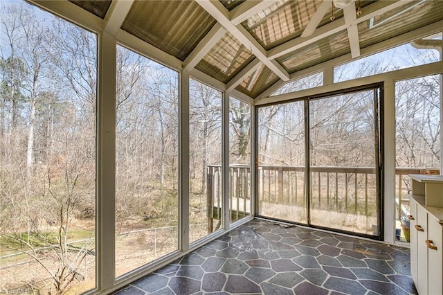 unfurnished sunroom featuring coffered ceiling and lofted ceiling with beams