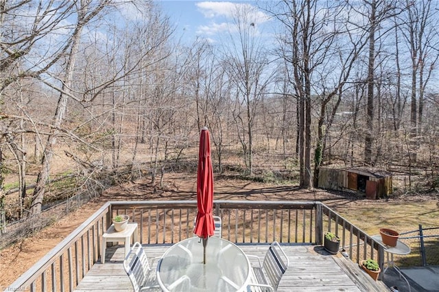 deck with an outbuilding and outdoor dining area