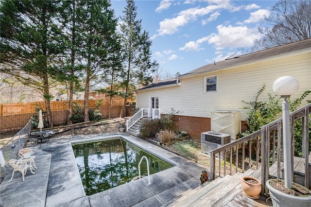 view of pool with a patio, central AC, stairs, and fence