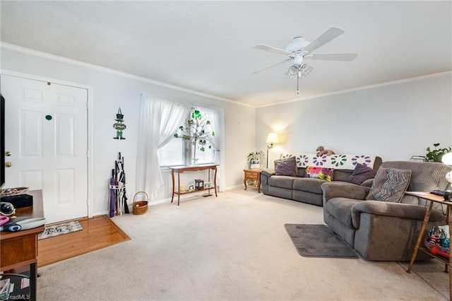 living room with crown molding, baseboards, carpet floors, and ceiling fan