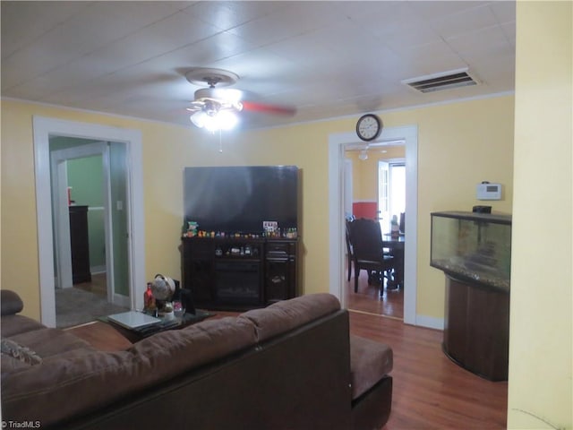 living room featuring ceiling fan and hardwood / wood-style flooring