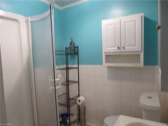 bathroom with tile walls and toilet