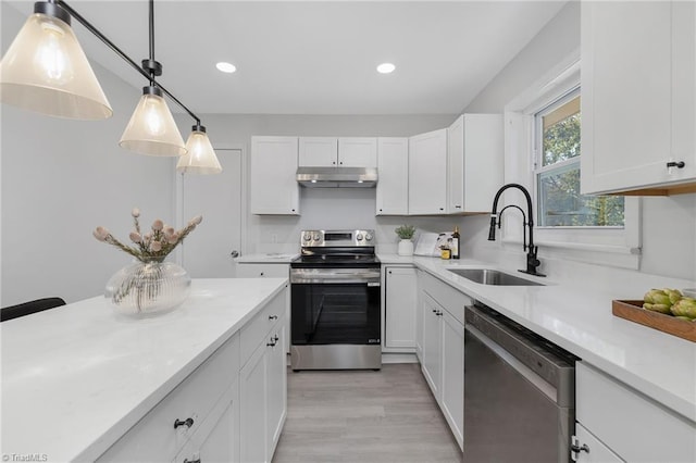 4420 Chebar Dr, Pfafftown, NC 27040 - kitchen with stainless steel appliances, a sink, under cabinet range hood, light countertops, and white cabinets