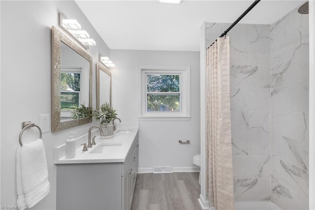 4420 Chebar Dr, Pfafftown, NC 27040 - bathroom with wood finished floors, a shower with shower curtain, double vanity, baseboards, and toilet