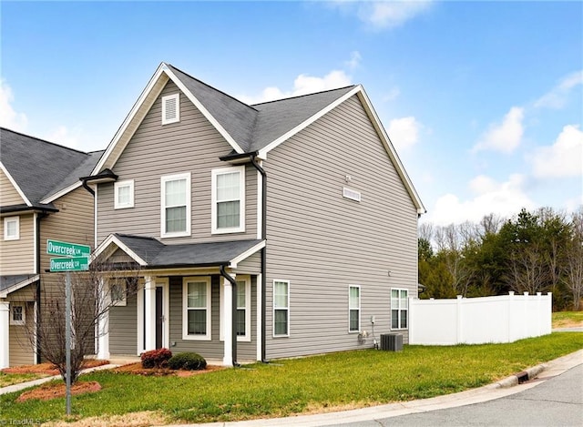 view of front of property featuring central AC and a front yard