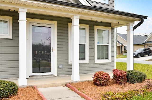 view of exterior entry with a porch