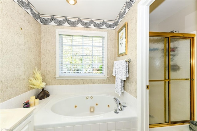 full bath featuring a stall shower, a whirlpool tub, and vanity