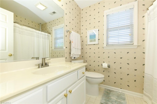 full bath featuring wallpapered walls, plenty of natural light, toilet, tile patterned floors, and vanity