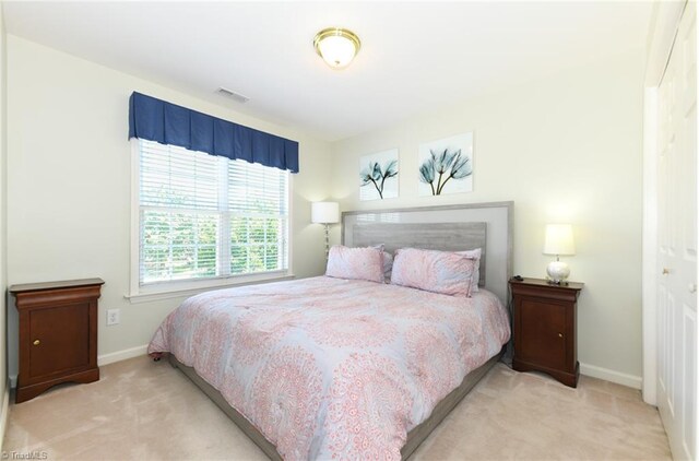 bedroom with carpet flooring and baseboards