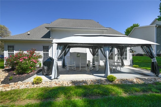 back of house featuring a gazebo, a patio area, and roof with shingles