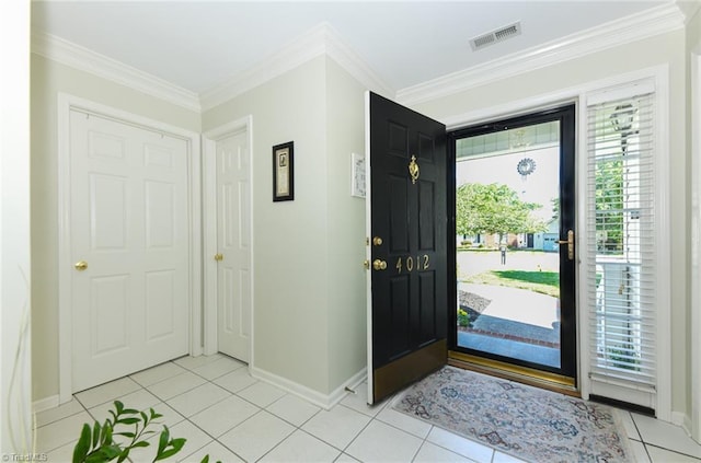 foyer entrance featuring light tile patterned floors, baseboards, and ornamental molding