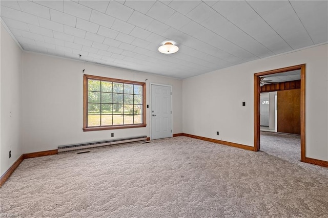 carpeted spare room featuring baseboards and a baseboard radiator