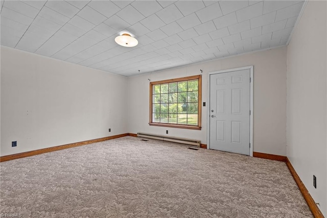 unfurnished room with a baseboard heating unit, baseboards, and carpet