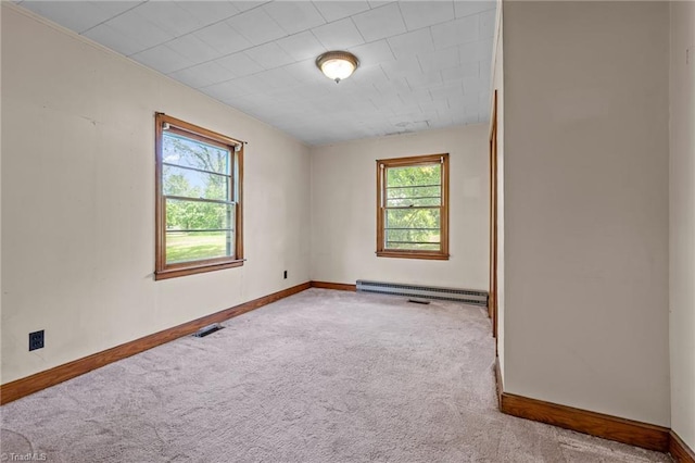 carpeted empty room with baseboards, visible vents, and a wealth of natural light